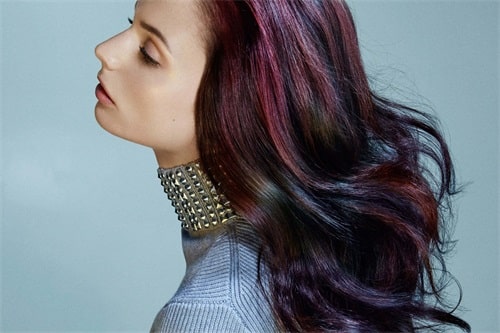 The oil slick hair color incorporates dark, iridescent tones of blue, purple, magenta, green and red. 