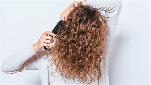 Brush your hair with your fingers or a wide-toothed comb