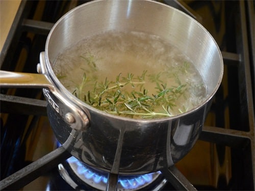 Put the rosemary in a pan with the water and bring to the boil